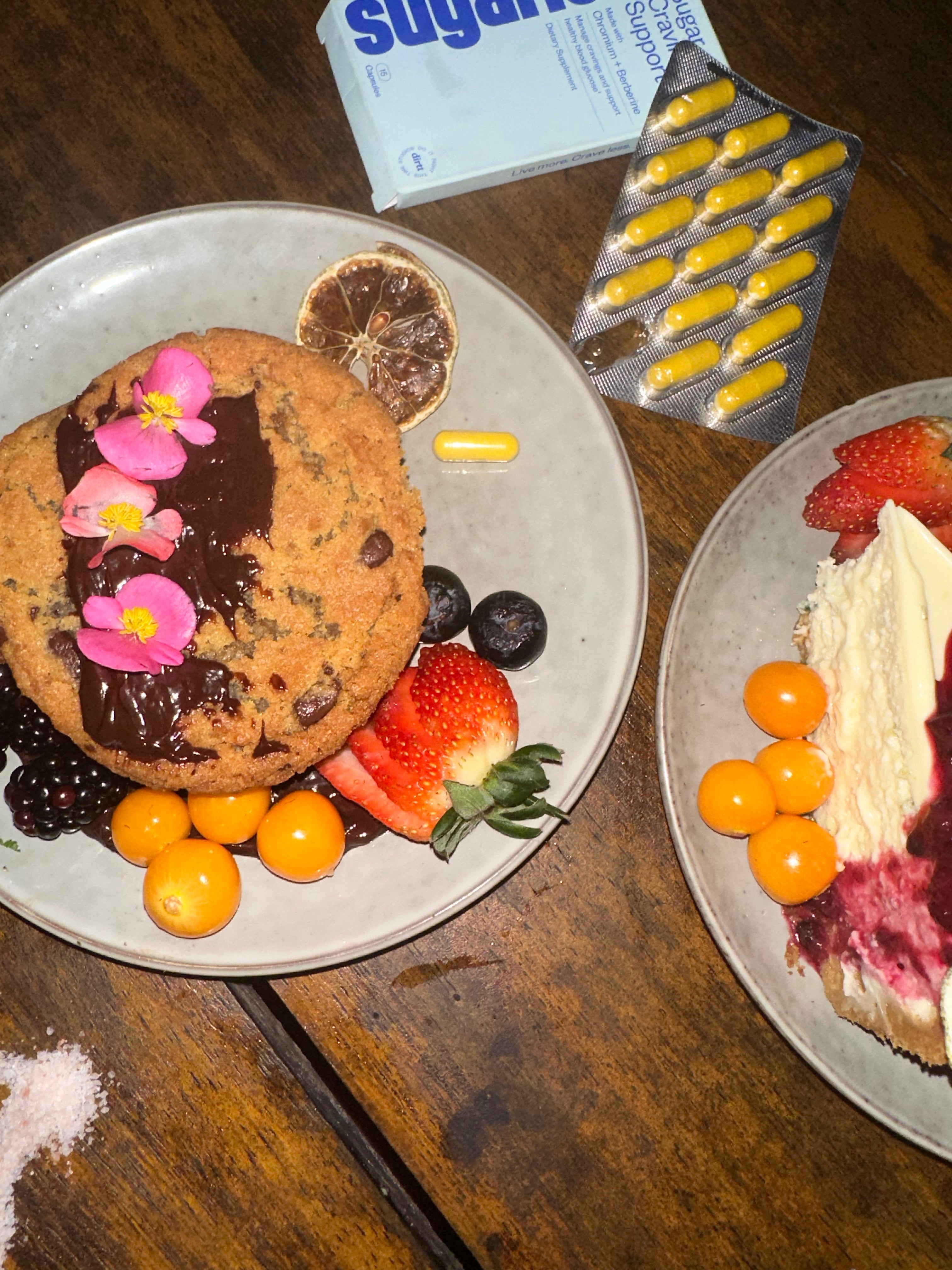 A picture of a box of Sugarless sugar cravings supplement with berberine and chromium on a dinner table with two plates of dessert