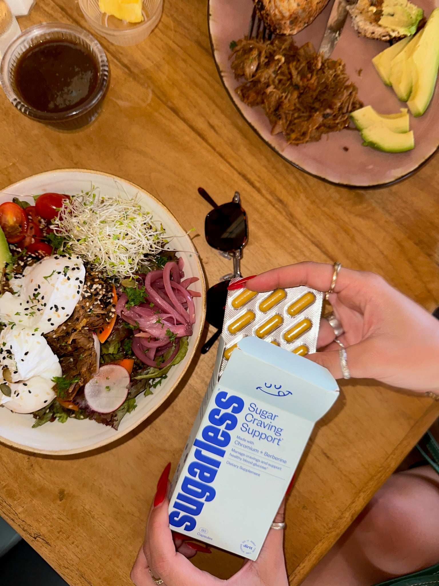 a box of Sugarless sugar cravings supplement with berberine and chromium on a dinner table with a plate of healthy looking food