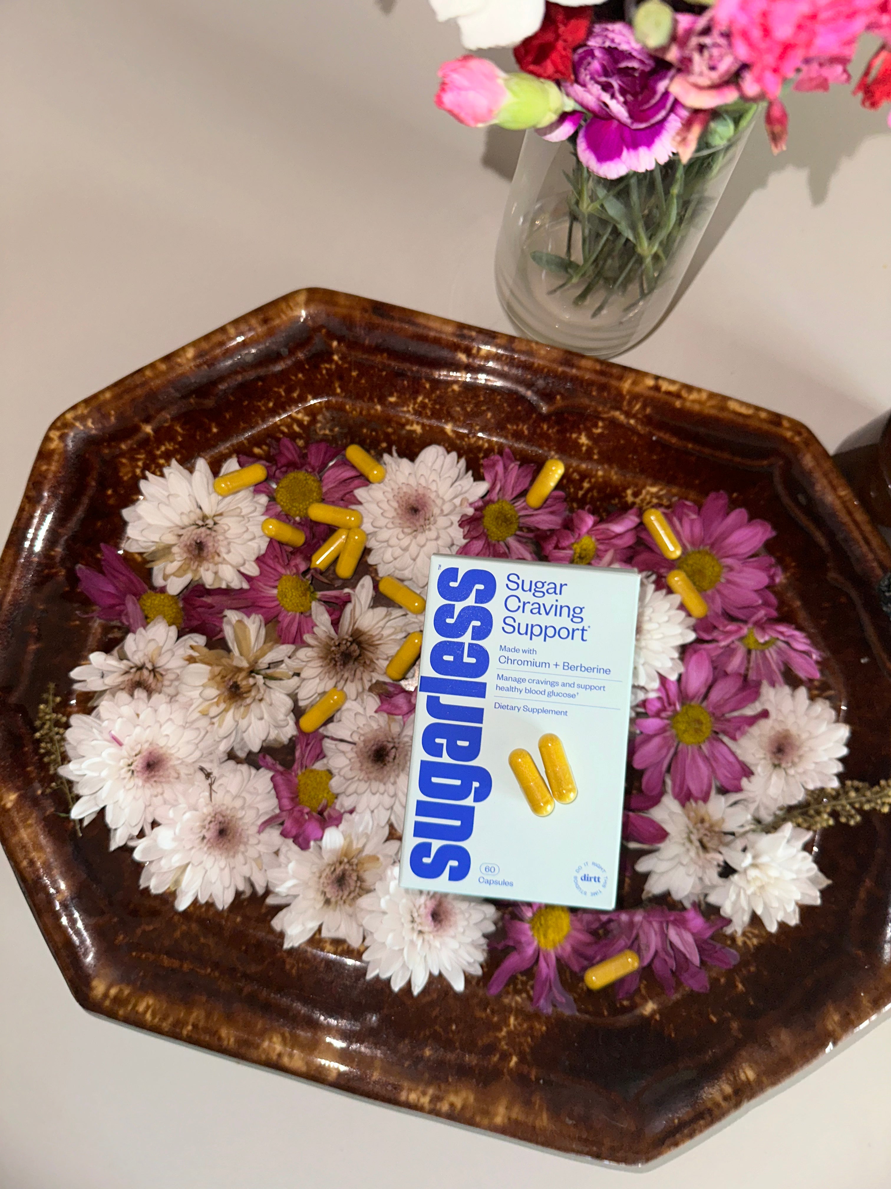 a box of Sugarless sugar cravings supplement with berberine and chromium in a floating basket of flowers